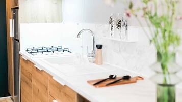 Fridge, microwave, coffee/tea maker, cookware/dishes/utensils