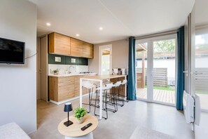 Fridge, microwave, coffee/tea maker, cookware/dishes/utensils