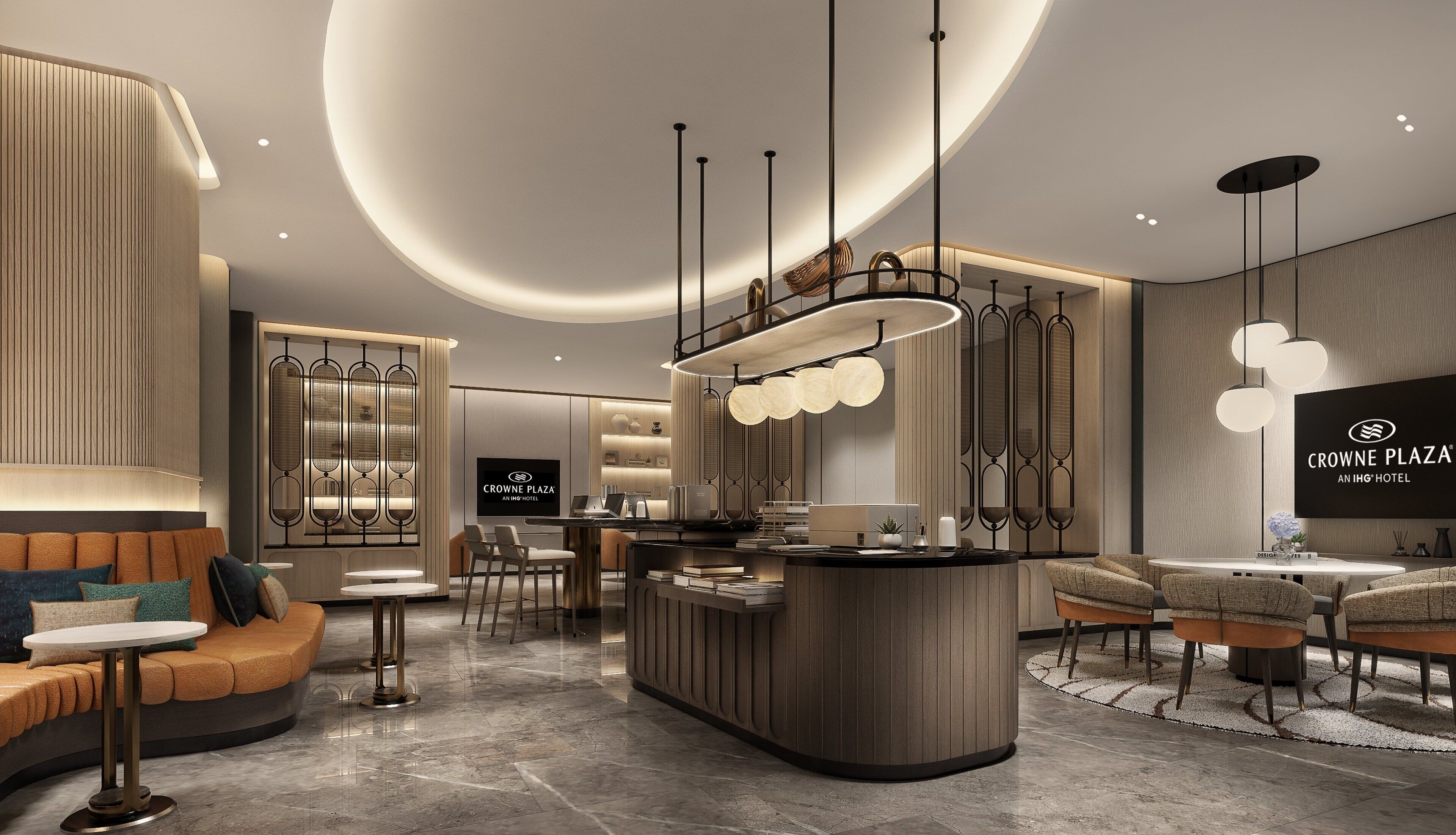 A modern hotel lobby with a central reception desk, seating areas, and a large screen displaying the hotel name.