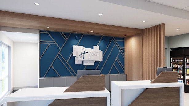 A modern reception desk area with a blue geometric wall design, wooden accents, and a visible reception counter. - Holiday Inn Express & Suites Jonesboro by IHG (Jonesboro)