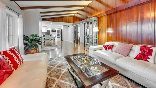 A spacious living room with a white sofa, a coffee table, and a chandelier. - Marvelous 3-bedroom townhome with  Heated floor Manchester (Manchester)