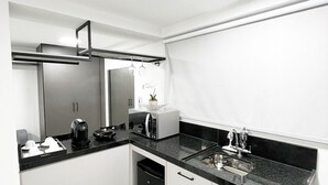 Een moderne keuken met een vaatwasser, een koffiezetapparaat en een magnetron.