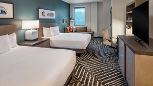 A hotel room with two beds, a desk with a flat-screen TV, a sofa, and a large window offering a view of the outdoors. - Hyatt House Destin (Destin)