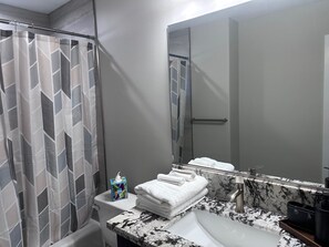 Shower, hair dryer, towels, toilet paper