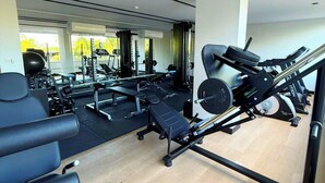 A gym with various exercise equipment including treadmills, weight machines, and free weights. - Dutra Ocean Flat By DayByDay (Joao Pessoa)