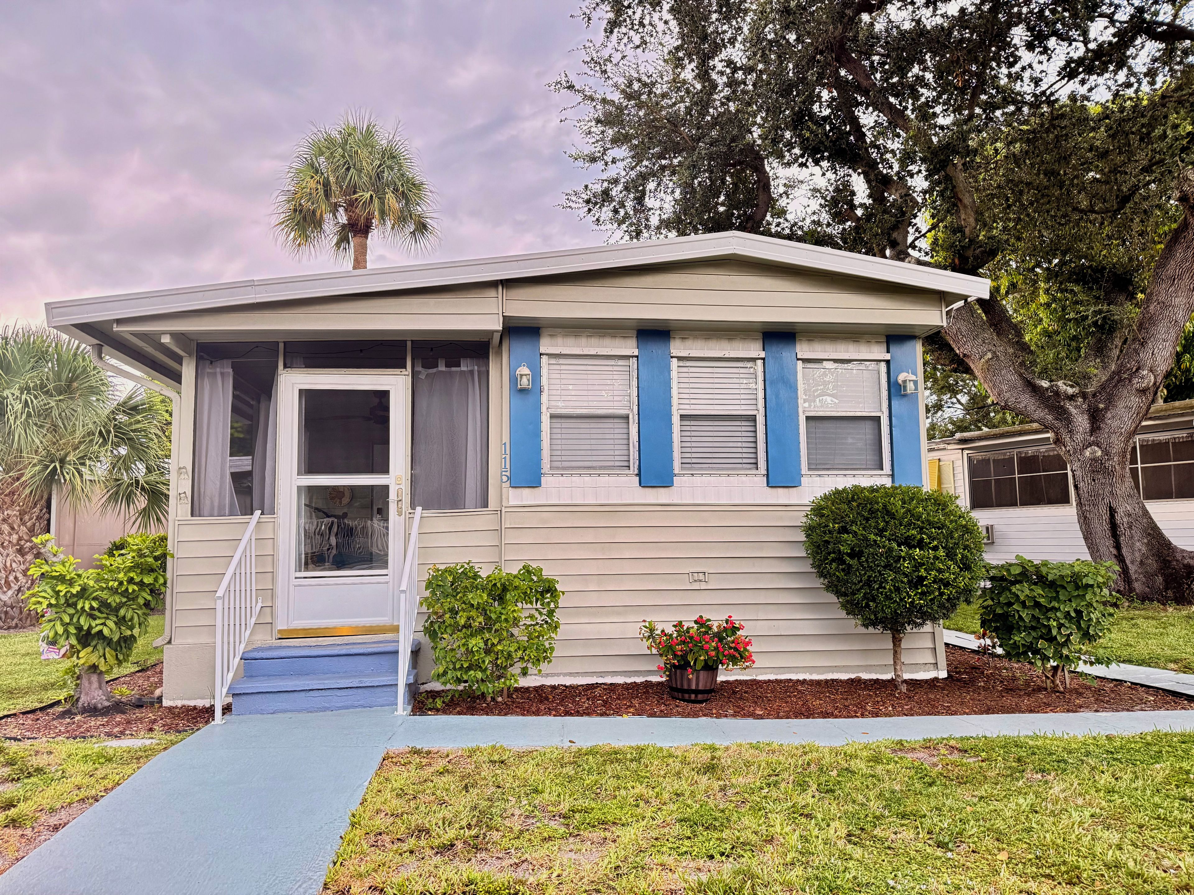 A single-story house with a front porch, a small front yard, and a mailbox.