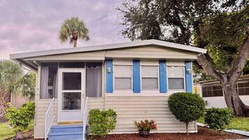A single-story house with a front porch, a small front yard, and a mailbox.