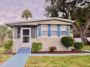 A single-story house with a front porch, a small front yard, and a mailbox.