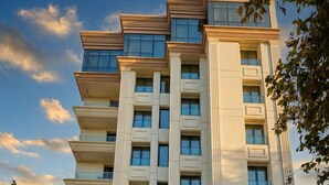 A multi-story hotel with a modern facade, a prominent entrance, and a flag indicating it is a hotel. - Hôtel St. Eugène (Algiers)