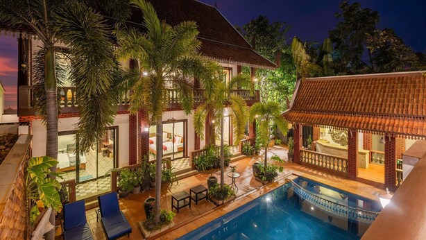 A hotel with a swimming pool, multiple rooms, and lush greenery. - 6 Rooms Exclusive Villa in Siem Reap — Wellness & Culture Immersion (Siem Reap)