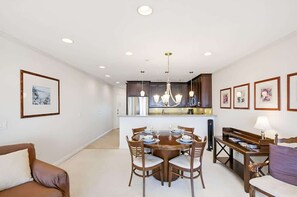 A modern interior with a dining area, kitchen, and living space. - Beach View Condo in the heart of Pacific Beach! (San Diego)
