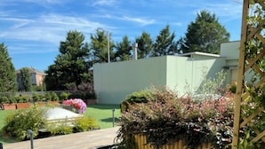 A well-maintained outdoor area with a sign reading "Wellhome Asti". - WellHome Asti (Asti)