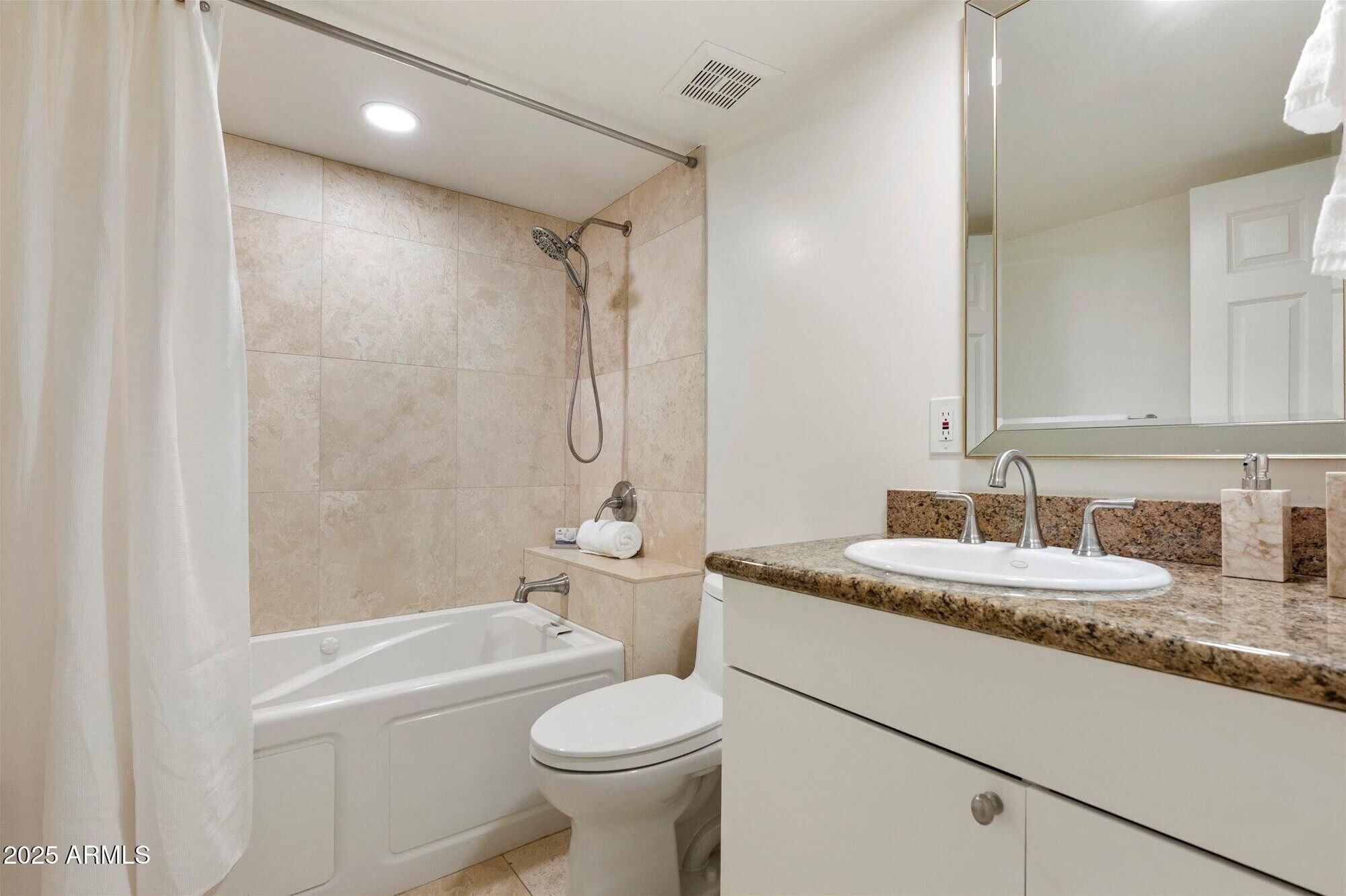 A bathroom with a bathtub, toilet, sink, and shower.