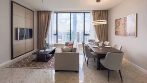 A modern living room with a dining area, large windows, and a city view. - Luxe 3R2B Pav Ceylon Bukit Bintang KLCC 600MBPS (Kuala Lumpur)