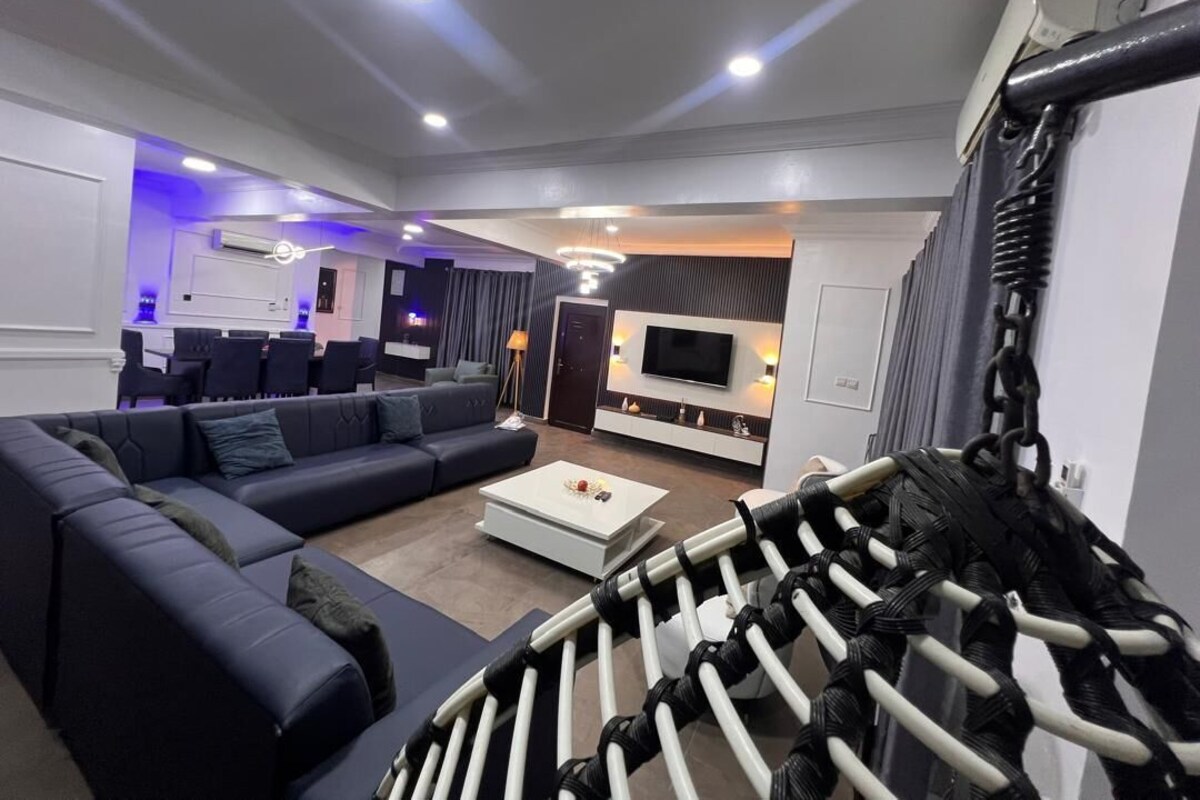 A modern living room with a sectional sofa, a coffee table, and a TV.