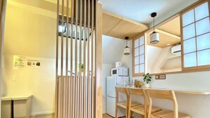 A modern kitchen with wooden furniture, a refrigerator, and a microwave. - H401 ＊[New] Tokyo luxury guesthouse｜Japanese style 2DK｜Honjo-Azumabashi station & direct airport access｜Near Asakusa & Skytree (墨田区)