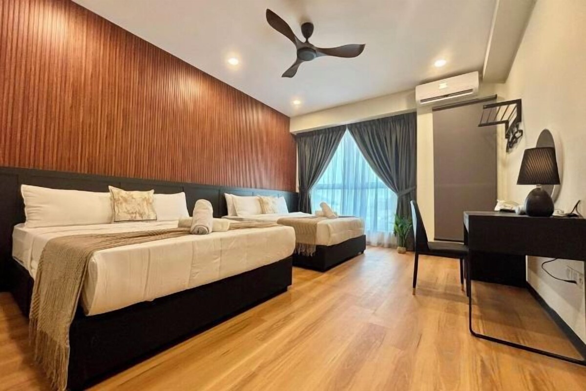 A modern hotel room with a large bed, a desk, and a ceiling fan.
