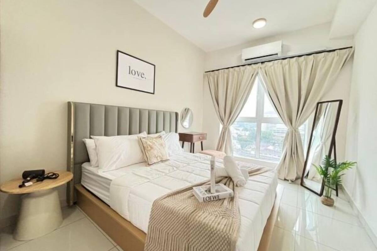 Un dormitorio moderno con cama, mesita de noche y ventana con cortinas.