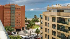 A coastal building with a view of the sea, featuring multiple floors and balconies. - H2M Pacificio Seaview & Terrace & Common Pool (Malaga)
