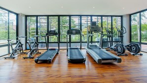 A gym with treadmills, elliptical machines, and weight equipment. - 405 Relife , 5 Minutes Walk To Nai Harn Beach (Rawai)