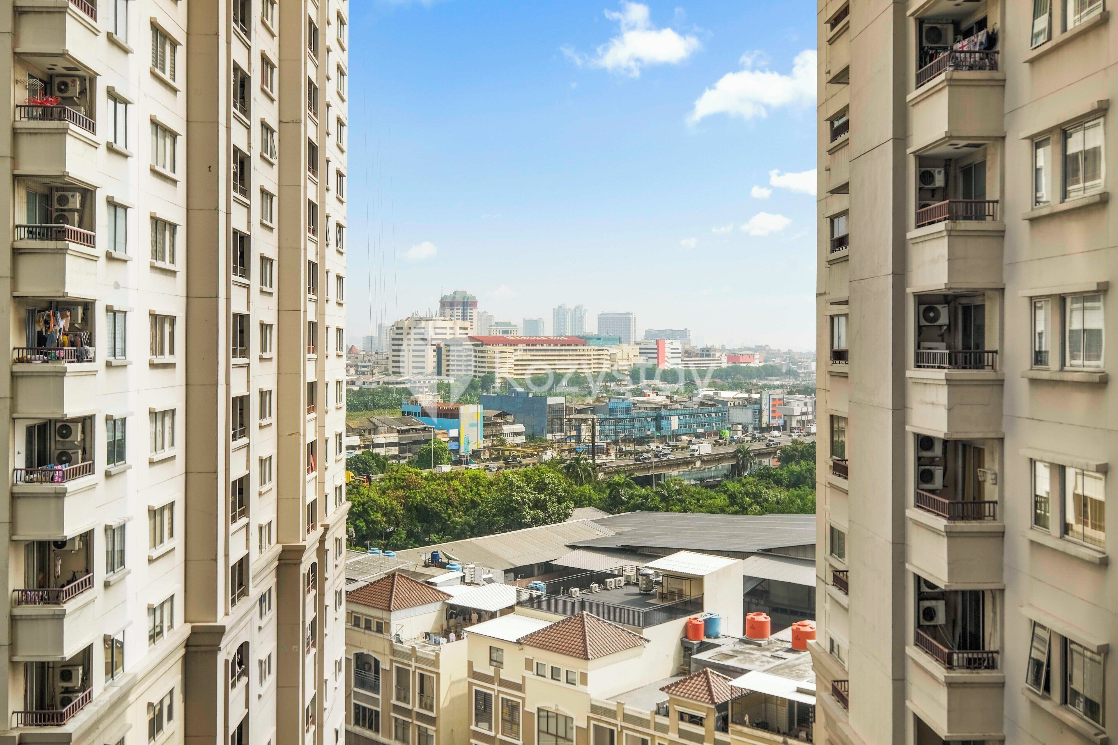A high-rise building with multiple balconies and air conditioning units.