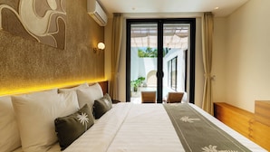 A spacious hotel room with a large bed, a view of the outdoor area, and a modern design. - Villa Thre by Pertama Stay (Canggu)