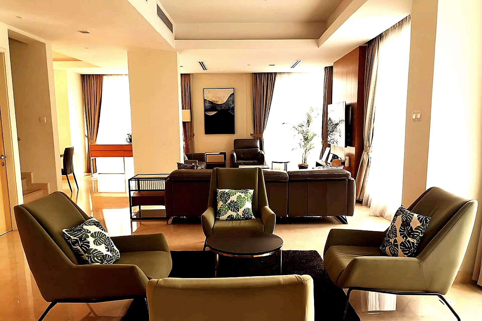 A living room with a sofa set, a coffee table, and a television.
