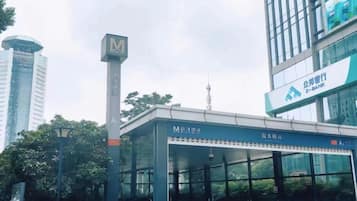 A modern building with a prominent 'M' sign, a glass facade, and a sign for 'Z-BANK'.