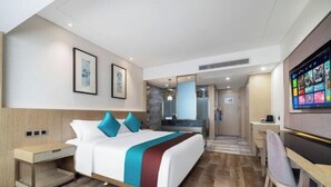 A hotel room with a bed, bedside table, desk, chair, and a TV. - Wuhan Zhongshan Park Xuesong Road (Wuhan)