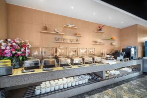 A buffet setup with multiple serving stations, a coffee machine, and a refrigerator. - Licheng Hotel (Wuhan Hankou Financial Center Wansongyuan Food Street) (Wuhan)