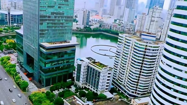 A high-rise urban area with modern buildings, a river, and a road with vehicles. - Wuhan Zhongshan Park Xuesong Road (Wuhan)