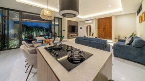 A modern kitchen with a central island, dining area, and seating space. - Villa Noema 2 - Brand New 2BR Villa with Pool (Badung)