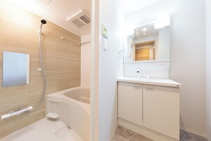 Separate bathtub and shower, free toiletries, hair dryer, slippers