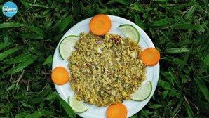 A plate of food with lime wedges and a carrot on a white plate, set on grass. - Dolubari Eco Resort Sreemangal (Kamalganj)