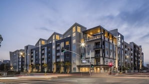 A modern multi-story hotel with a prominent '4' on the facade, indicating it is part of a larger complex. - Clean Cozy and Calm Retreat (Glendale)