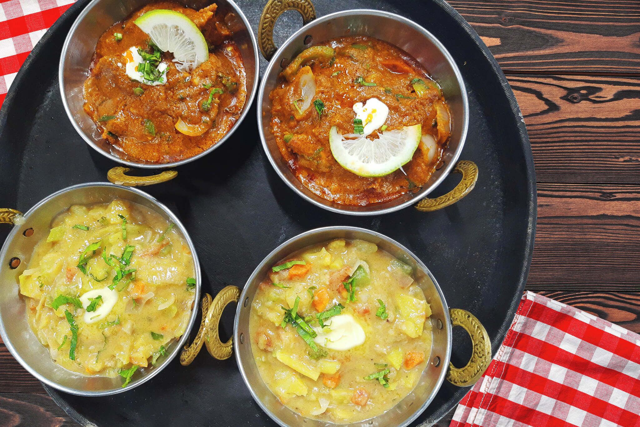 Three bowls of food on a tray.