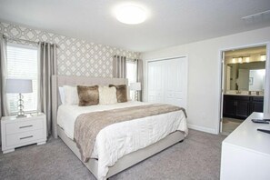 A bedroom with a bed, nightstands, a dresser, and a walk-in closet. - Storey Lake 4 Bedroom Vacation Home 4844 (Kissimmee)