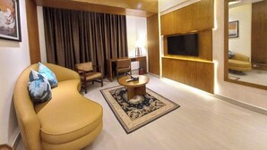 A modern living room with a sofa, a coffee table, a TV, and a large mirror. - Royal Pearl Apartment&Suites Cox's Bazar (Cox's Bazar)
