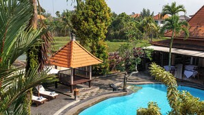 A pool area with lounge chairs and a small pavilion. - Awatara Villas and Resort Ubud (Kemenuh)