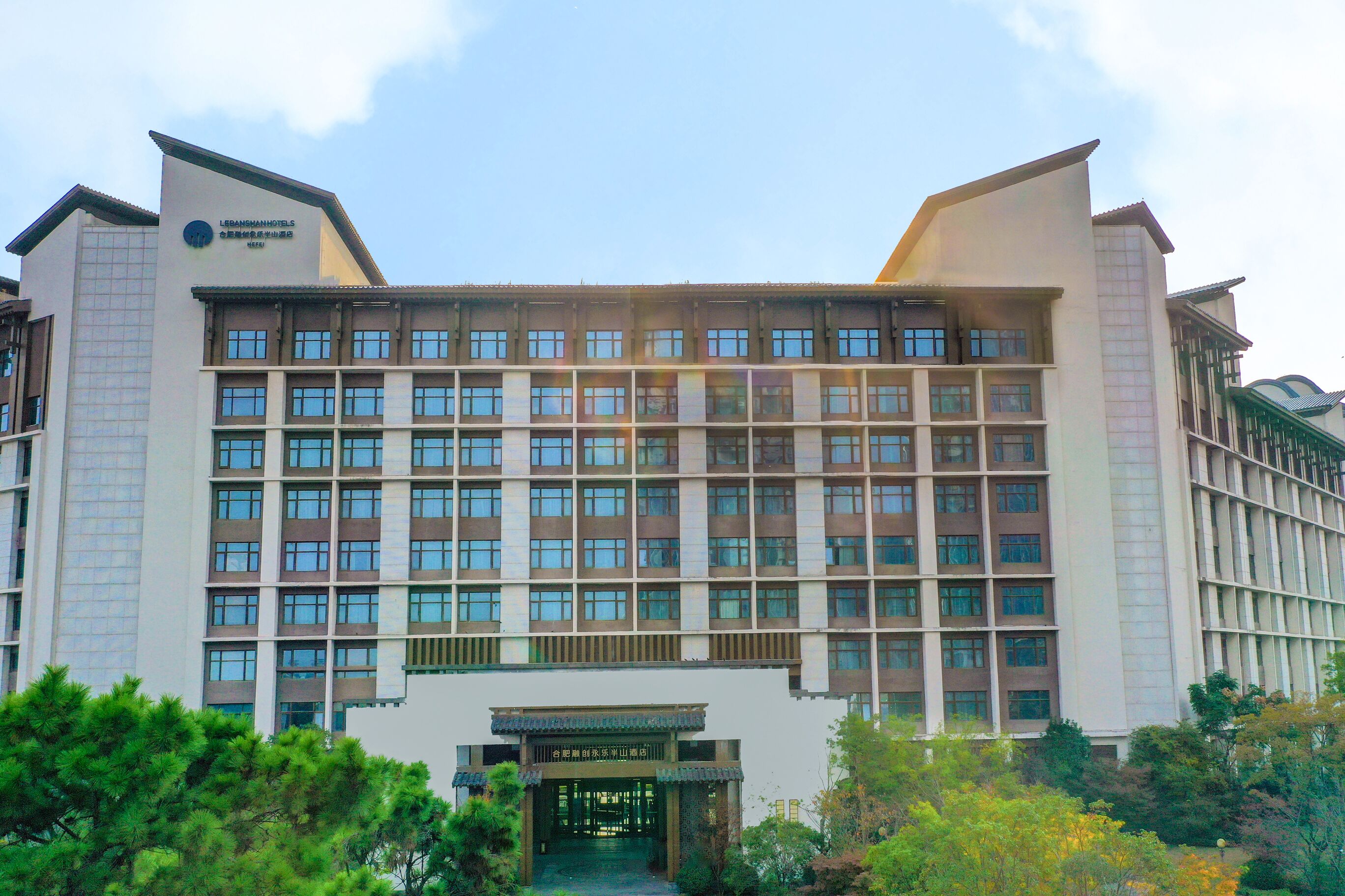 A large hotel building with multiple floors and a traditional entrance.