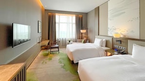 A hotel room with two beds, a flat-screen TV mounted on the wall, a desk with a chair, a lamp, and a large window with curtains. - LEBANSHAN HOTELS HEFEI (Hefei)