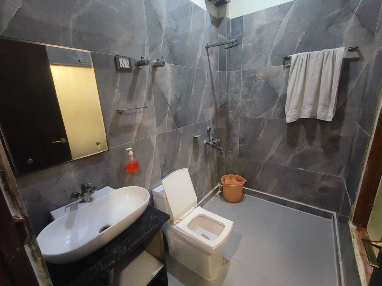 A bathroom with a sink, toilet, and shower.