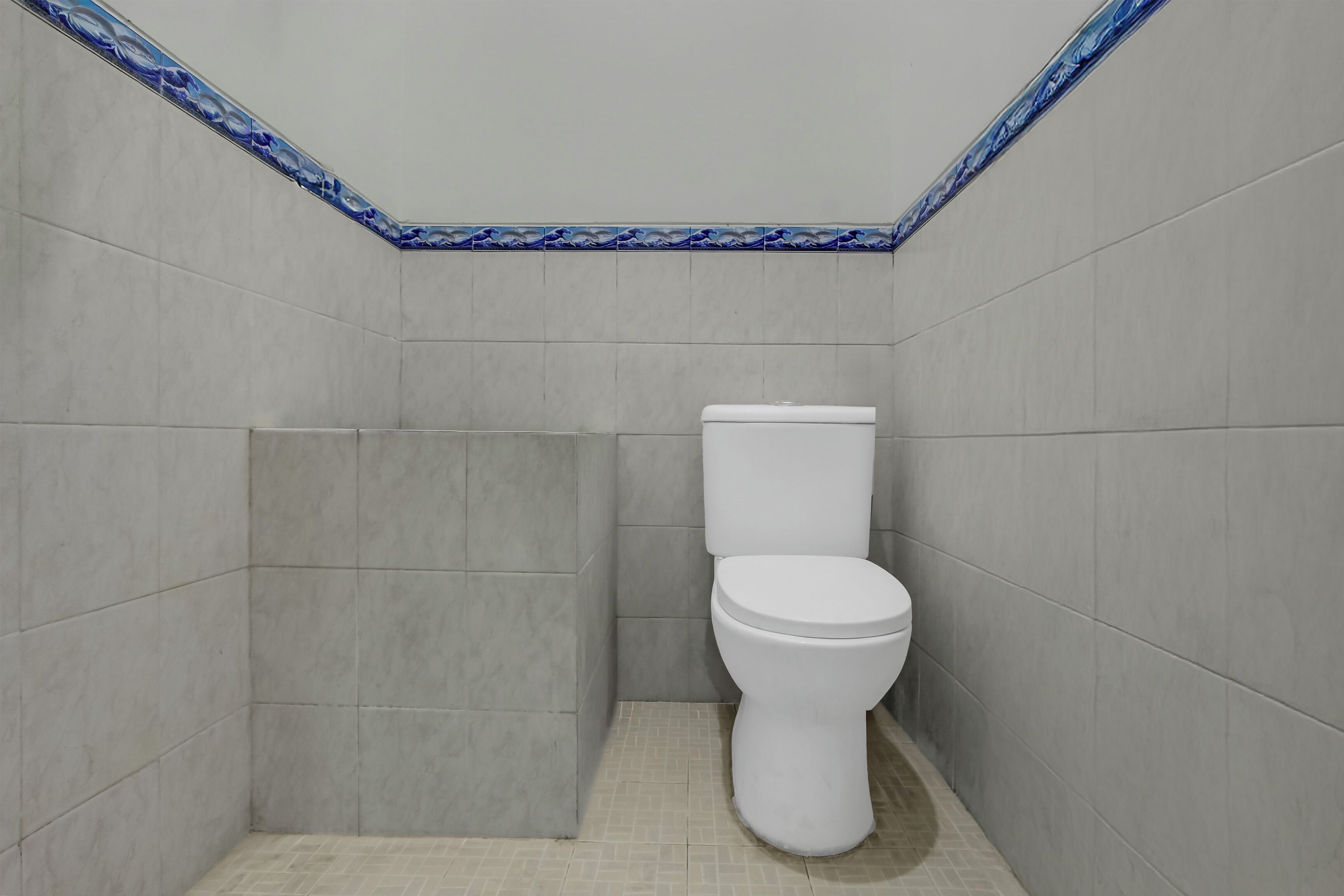 A small, enclosed bathroom with a toilet and a shower stall.