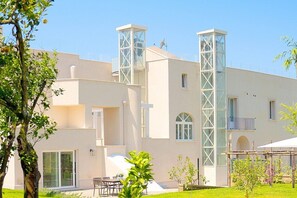 A modern building with a flat roof, large windows, and a central tower. - Villa Auralia Grande: A charming and bright two-story historical villa surrounded by a lemon and orange garden, with Free WI-FI. (Massa Lubrense)