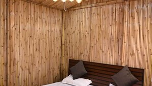 A room with a wooden slatted ceiling, a bed with white bedding, and a hanging light fixture. - Sanskriti Homestay & Cottage (Dhari)