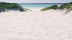 A beach with white sand and a clear blue sea. - PgaVillageResort by AmericanVacationLiving 2 Br (St. Lucie County)