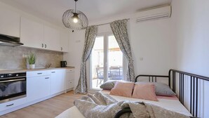 A compact bedroom with a bed, a bedside table, and a window with curtains. - 1 bedroom lovely apartment in Sveti Petar na Moru (Sveti Petar na Moru)