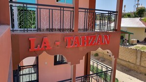 A building with a sign reading "LA-TAHZAN". - Latahzan guest house (Moyale)