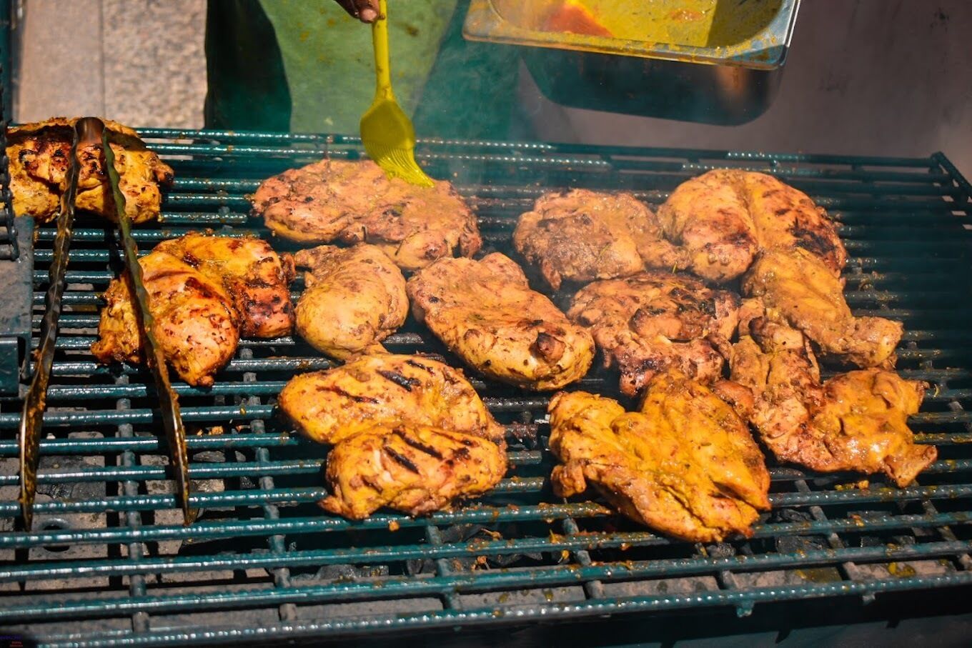 A grill with various meats being cooked.