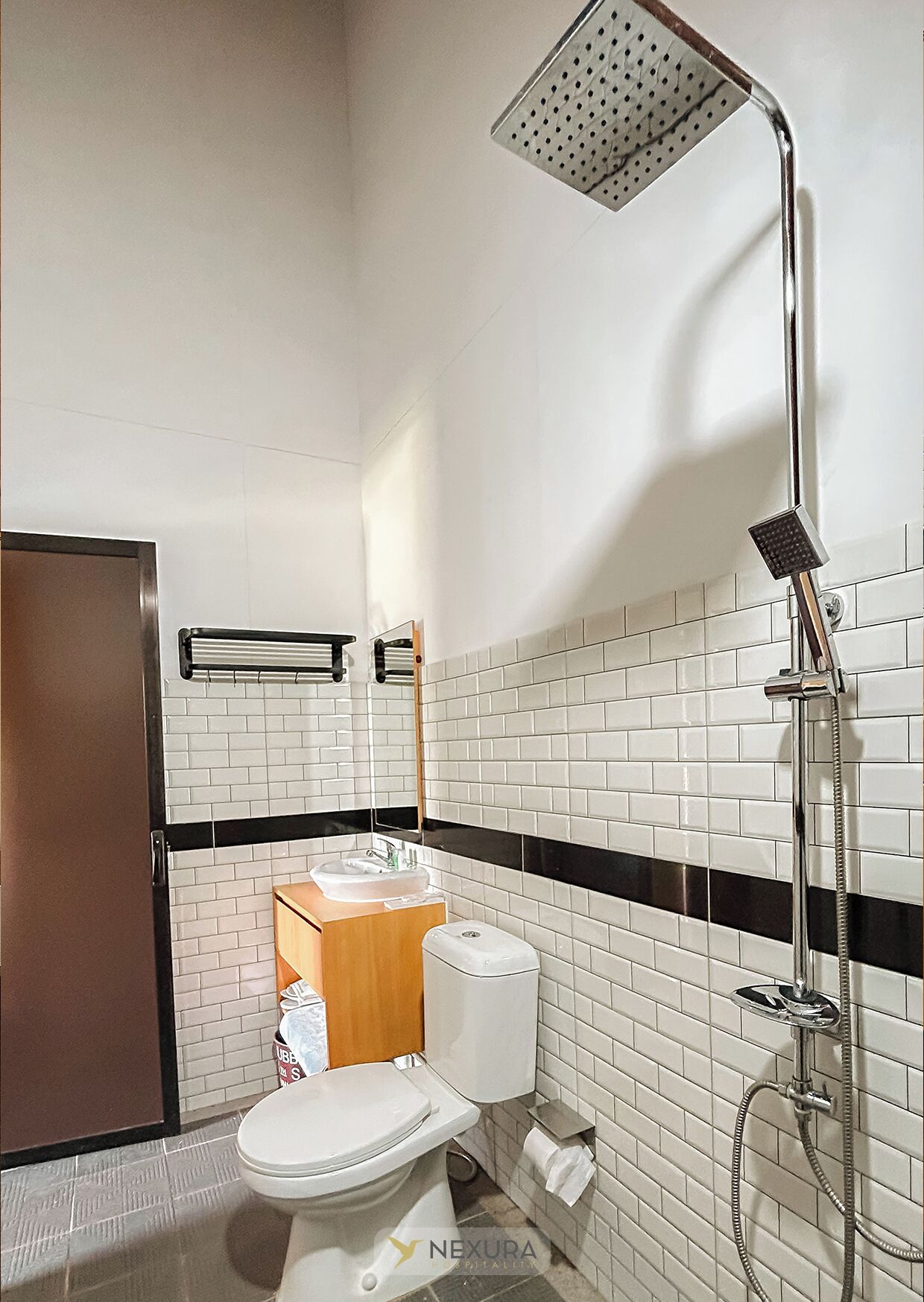A modern bathroom with a toilet, sink, and shower.